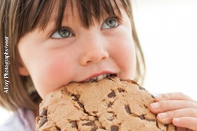 Kinder greifen gern zu Süßem. Eltern sollte auf eine ausgewogene Ernährung ihrer Sprösslinge achten.